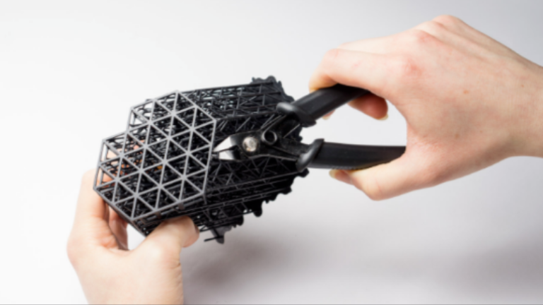 This is an image showing the removal of model supports after a 3D printer has completed its work.